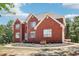 Charming red brick home with a manicured lawn and walkway leading to the front entrance at 1424 Brighton, Loganville, GA 30052