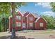 Beautiful red brick two-story home featuring a manicured lawn and a welcoming front entrance at 1424 Brighton, Loganville, GA 30052