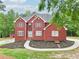 Charming two-story brick home with manicured lawn, walkway and landscaping at 1424 Brighton, Loganville, GA 30052