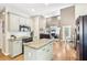Open kitchen and living room with hardwood floors, granite island, and stainless steel appliances at 1424 Brighton, Loganville, GA 30052