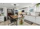 Well-lit kitchen features an island with seating, stainless steel appliances, white cabinetry, and ample counter space at 1424 Brighton, Loganville, GA 30052