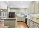 Spacious kitchen with an island, ample counter space, stainless steel appliances, and hardwood floors at 1424 Brighton, Loganville, GA 30052