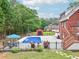Private in-ground pool surrounded by lush greenery, lounge chairs and manicured yard at 1424 Brighton, Loganville, GA 30052