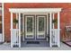 Closer view of covered rear entryway showing flowers and brick at 1424 Brighton, Loganville, GA 30052
