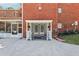 Covered rear entryway showing brick, porch with flowers, and view to pool at 1424 Brighton, Loganville, GA 30052