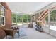 Bright sun room with brick wall, tile flooring, and backyard views at 1424 Brighton, Loganville, GA 30052