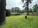 Large, grassy backyard with trees and privacy fence. Back exterior view of home at 1909 Cindy Dr, Decatur, GA 30032