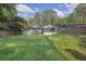 Spacious backyard of property, partially bordered by a wooden fence at 1909 Cindy Dr, Decatur, GA 30032