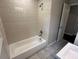 Neutral bathroom featuring a tub/shower with tile surround, shower head, and vanity sink at 1909 Cindy Dr, Decatur, GA 30032