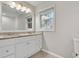 Bright bathroom featuring a double sink vanity, neutral walls, and a window for natural light at 1909 Cindy Dr, Decatur, GA 30032