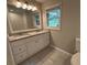 Bright bathroom featuring double vanity with granite counters, tile floors, and a large mirror at 1909 Cindy Dr, Decatur, GA 30032