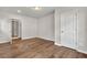 This bedroom has hardwood floors, neutral paint, and an ensuite bathroom at 1909 Cindy Dr, Decatur, GA 30032