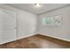 This bedroom has a window with backyard view and hardwood floors at 1909 Cindy Dr, Decatur, GA 30032