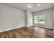 This bedroom has hardwood floors, neutral paint, and a large window with a backyard view at 1909 Cindy Dr, Decatur, GA 30032