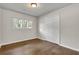 Bedroom with wood floors, closet, and window providing natural light, creating a cozy and inviting space at 1909 Cindy Dr, Decatur, GA 30032