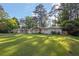 Inviting home with a lush green lawn, mature trees, and a freshly painted exterior at 1909 Cindy Dr, Decatur, GA 30032