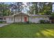 Charming single-story home featuring a well-maintained lawn and inviting orange front door at 1909 Cindy Dr, Decatur, GA 30032