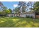 Inviting home with a lush green lawn, mature trees, and a freshly painted exterior at 1909 Cindy Dr, Decatur, GA 30032