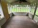 Enclosed sun room featuring pane windows, concrete block base, faux wood tile flooring and ceiling fan at 1909 Cindy Dr, Decatur, GA 30032