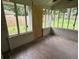Enclosed sun room featuring pane windows, concrete block base, faux wood tile flooring and ceiling fan at 1909 Cindy Dr, Decatur, GA 30032