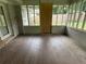 Enclosed sun room featuring pane windows, concrete block base, faux wood tile flooring and door at 1909 Cindy Dr, Decatur, GA 30032
