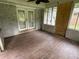 Enclosed sun room featuring pane windows, concrete block base, faux wood tile flooring and french doors at 1909 Cindy Dr, Decatur, GA 30032