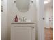 Bathroom with white vanity, oval mirror, neutral walls, and a wooden-style floor at 2055 Summer View Place Sw, Marietta, GA 30060