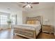 Bright primary bedroom suite featuring a tray ceiling and wood-look floors at 2055 Summer View Place Sw, Marietta, GA 30060