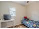 Cozy bedroom featuring a twin bed, desk, and a window providing natural light at 2055 Summer View Place Sw, Marietta, GA 30060