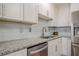 Beautiful kitchen with stainless steel dishwasher, granite countertops, and white tile backsplash at 2055 Summer View Place Sw, Marietta, GA 30060