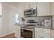 Modern kitchen with stainless steel appliances, granite countertops, and white cabinetry at 2055 Summer View Place Sw, Marietta, GA 30060