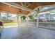 Large, covered outdoor patio with ceiling fan, wood ceiling, and ample space for entertaining at 2055 Summer View Place Sw, Marietta, GA 30060