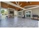 Covered patio featuring ceiling fans, a TV, and outdoor seating for entertaining guests at 2055 Summer View Place Sw, Marietta, GA 30060