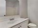 Bathroom featuring white vanity and sink, a modern faucet, a mirror and a toilet at 5634 Windwood Rd, Atlanta, GA 30349
