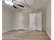 Bedroom featuring neutral walls, ceiling fan, and wood-look laminate flooring and two closets at 5634 Windwood Rd, Atlanta, GA 30349
