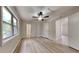 Bright and spacious bedroom with laminate floors and a ceiling fan and a large window at 5634 Windwood Rd, Atlanta, GA 30349