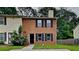 Traditional brick two-story home with dark shutters and a black front door on a small green lot at 5634 Windwood Rd, Atlanta, GA 30349