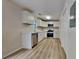 Bright, updated kitchen with white cabinetry, stainless steel appliances, and laminate floors at 5634 Windwood Rd, Atlanta, GA 30349