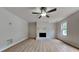 Bright living room featuring a white painted brick fireplace and light laminate flooring at 5634 Windwood Rd, Atlanta, GA 30349