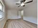 Spacious main bedroom features a ceiling fan, neutral walls, wood-look laminate flooring, and window at 5634 Windwood Rd, Atlanta, GA 30349