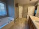 Bathroom featuring double sinks, soaking tub, a separate shower, and a window at 851 Walkingstick Dr, Douglasville, GA 30134