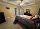 Bedroom with carpet, neutral walls, ceiling fan, and a comfortable bed with stylish bedding at 851 Walkingstick Dr, Douglasville, GA 30134