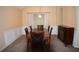 Traditional dining room with a dark wood table, six chairs, and modern buffet cabinet at 851 Walkingstick Dr, Douglasville, GA 30134