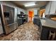 Spacious kitchen with gray cabinets, granite countertops, stainless steel appliances, and eye-catching flooring at 851 Walkingstick Dr, Douglasville, GA 30134