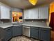 Stylish kitchen featuring gray cabinets, granite countertops, stainless steel appliances, and modern backsplash at 851 Walkingstick Dr, Douglasville, GA 30134