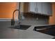Close-up of a kitchen sink and countertop featuring a stylish backsplash at 851 Walkingstick Dr, Douglasville, GA 30134