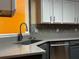 Modern kitchen featuring a stainless steel dishwasher, a dark sink, and light gray countertops at 851 Walkingstick Dr, Douglasville, GA 30134