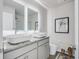 Modern bathroom featuring dual sinks, granite countertops, and decorative mirror lighting at 231 Ivey Ter, Temple, GA 30179