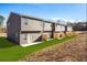 New townhome exterior with modern siding, green lawn, and individual patios at 231 Ivey Ter, Temple, GA 30179