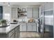 Well-lit kitchen featuring stainless steel appliances, granite countertops, and light gray cabinetry at 231 Ivey Ter, Temple, GA 30179